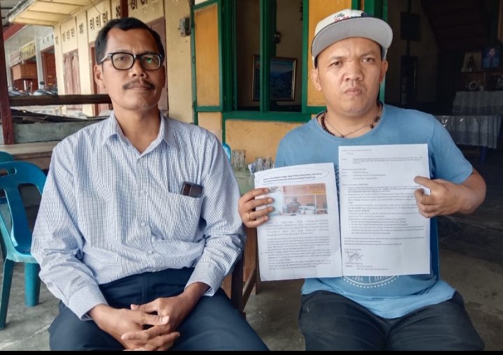 Kuasa hukum Sahala Ervan Saragih, SH dan pengusaha UD Dainang Santo Marpaung memegang berkas keberatan terhadap media yang dibantah. (Ist)