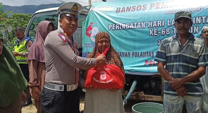 Kasat Lantas Polres Labuhanbatu AKP M Ainul Yaqin SIK memberikan sembako kepada warga Talsim dalam giat pembagian Air bersih. (IST)