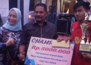Drs H Rahudman Harahap MM menyerahkan hadiah untuk tim yang meraih juara 1 turnamen Sepak Bola Rahudman Cup Delitua 2023. (SAMURA)