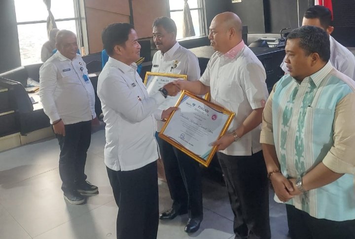 Bupati Taput Dr.Drs.Nikson Nababan,MSi saat menerima penghargaan dari Pj.Gubsu Hassanuddin, Rabu (29/11/2023). (IST)