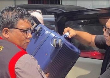 Petugas Kejari Pematangsiantar membawa 1 unit koper yang diduga berisi dokumen.