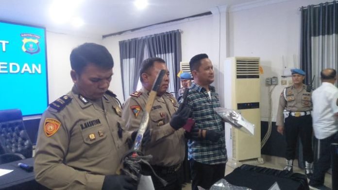 Kepolisian menunjukan barang bukti senjata api dan senjata tajam milik tersangka. 