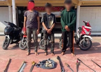 Ketiga remaja bersama barang bukti sejumlah senjata tajam saat diamankan di Polres Asahan.