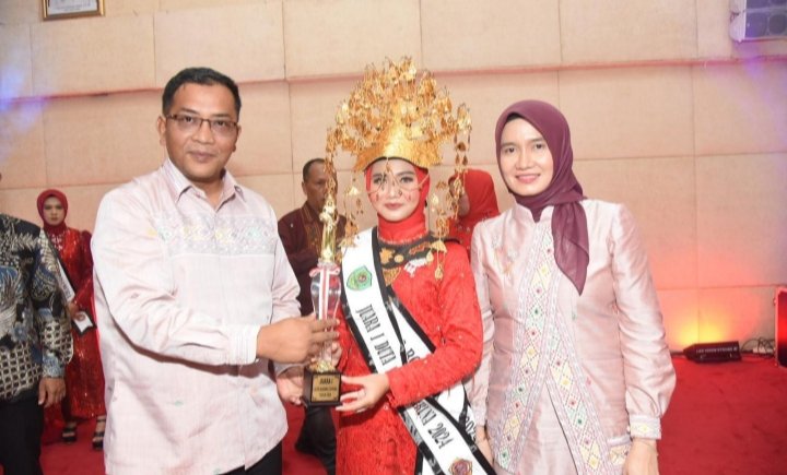 Plt. Bupati Tapsel Rasyid Assaf Dongoran dan Plt. Ketua TP. PKK Sri Rezeki Rasyid Assaf Dongoran menyerahkan piala ke"Boru Namora" 2024 Tapsel. (IST)