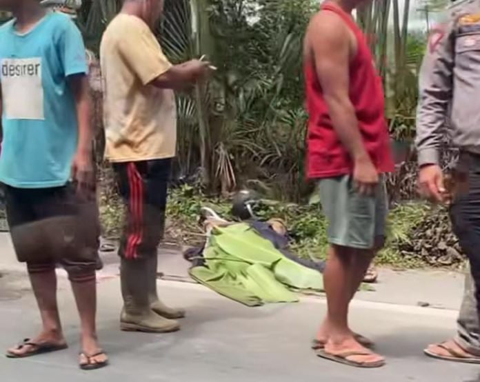 Kondisi pengendara sepeda motor ditutupi daun setelah mengalami kecelakaan.