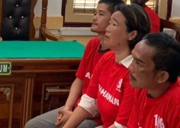 Kartika (tengah) bersama anaknya Nico (kiri) dan rekannya terdakwa Charles diadili di ruang sidang Cakra IV, Pengadilan Negeri Medan, Kamis (19/12/2024).